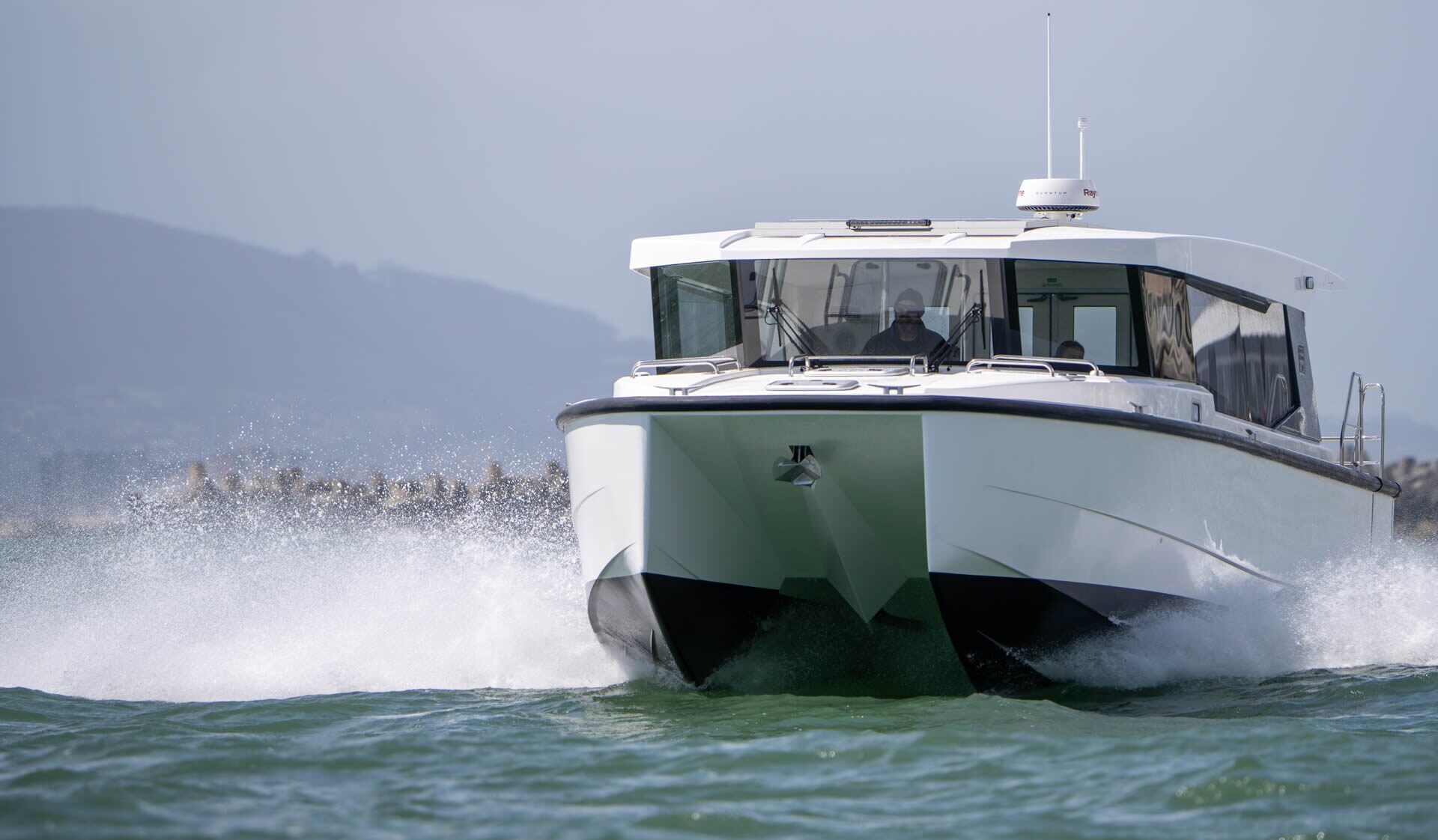 The 370 Luxury Shuttle running bow-on through spray
